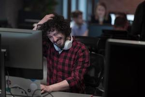 Disappointed businessman wearing headset having virtual team meeting group call chatting with diverse people in customer support. Video conference call on computer with manager and employees. photo