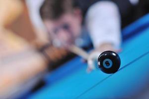 young man play pro billiard game photo