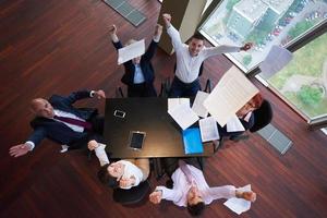 top view of business people group throwing dociments in air photo