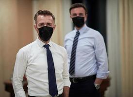 business team wearing crona virus protection face mask photo