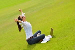 woman with laptop in park photo