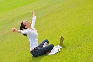 woman with laptop in park photo