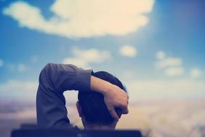 young man dreaming clouds on presentation photo