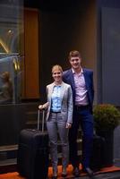 business people couple entering  hotel photo