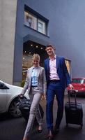 business people couple entering  hotel photo