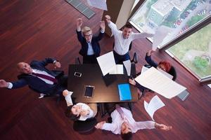 top view of business people group throwing dociments in air photo