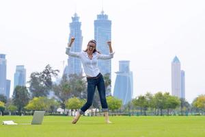 woman with laptop in park photo