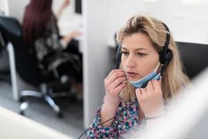 call center operator in medical mask photo