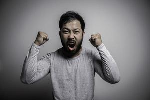 Portrait of Asian young man on white background,Angry man concept photo