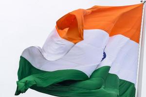 India flag flying high at Connaught Place with pride in blue sky, India flag fluttering, Indian Flag on Independence Day and Republic Day of India, tilt up shot, Waving Indian flag, Har Ghar Tiranga photo