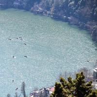 Full view of Naini Lake during evening time near Mall Road in Nainital, Uttarakhand, India, Beautiful view of Nainital Lake with mountains and blue sky photo