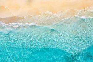 Relaxing aerial beach scene, summer vacation holiday template banner. Waves surf with amazing blue ocean lagoon, sea shore, coastline. Perfect aerial drone top view. Bright beach panorama, seaside photo