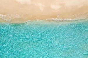 Beautiful aerial beach landscape, summer vacation holiday template banner. Waves surf with amazing blue ocean lagoon, sea shore, coastline. Amazing aerial drone top view. Relaxing bright beach seaside photo