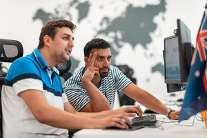 Group of Casual business man working on desktop computer in modern open plan startup office interior. Selective focus photo