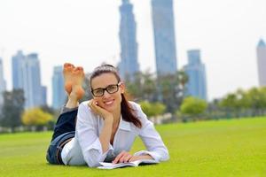 Young woman reading a book in the park photo