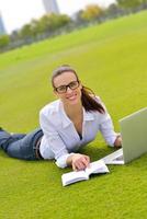 woman with laptop in park photo