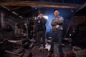 portrait of two generations confident blacksmith photo
