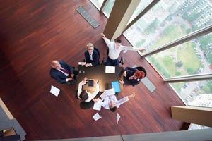 top view of business people group throwing dociments in air photo