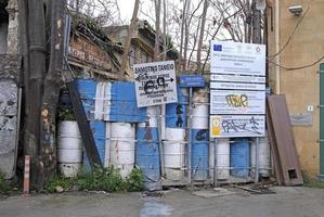 Nicosia, Cyprus, 2020 - Barbed wire and stacked barrels at the border zone Green Line in Nicosia, Cyprus photo