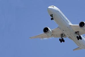 Approaching plane against a blue sky photo