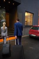 business people couple entering  hotel photo