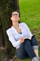 Young woman reading a book in the park photo