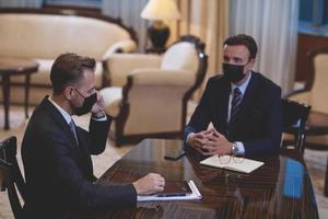 business people wearing crona virus protection face mask on meeting photo