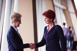 business womans make deal and handshake photo