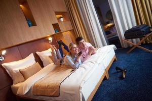 young couple in modern hotel room photo