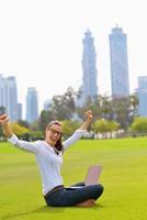 woman with laptop in park photo