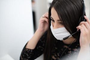 call center operator in medical mask photo