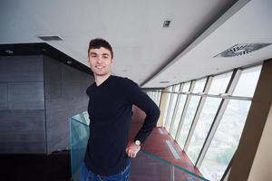 young successful man in penthouse apartment photo