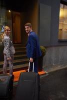 business people couple entering  hotel photo