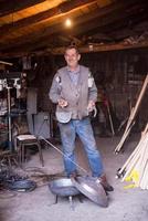 A blacksmith worker showing handmade products ready for sale photo