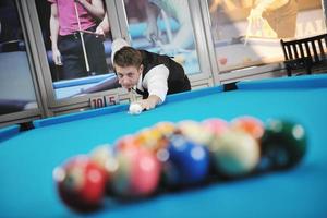 young man play pro billiard game photo