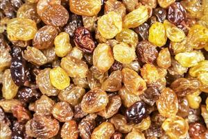 background of delicious sweet yellow raisins on the table close-up photo