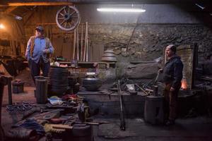 portrait of two generations traditional blacksmith photo