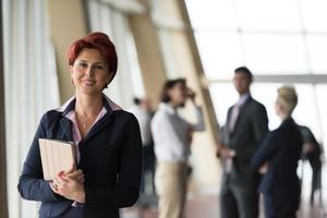 portrait of older business woman  at office with tablet computer photo