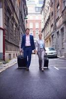 business people couple entering  hotel photo