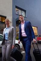 business people couple entering  hotel photo