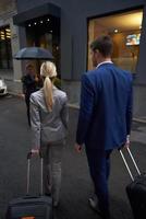 business people couple entering  hotel photo