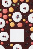 Macaron composition. Frame made of autumn berries and macarons. Autumn, fall concept. Flat lay, top view, copy space photo