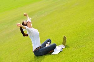 woman with laptop in park photo