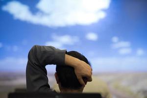 young man dreaming clouds on presentation photo