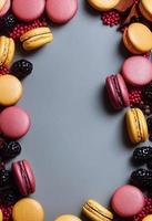 Macaron composition. Frame made of autumn berries and macarons. Autumn, fall concept. Flat lay, top view, copy space photo