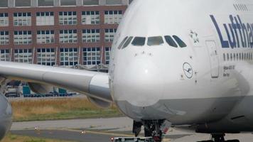 FRANKFURT AM MAIN, GERMANY JULY 17, 2017 - The tractor tows Lufthansa Airbus 380 D AIMH named  New York  to service. Fraport, Frankfurt, Germany video