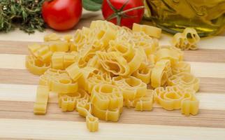 Pasta animal on wooden board and wooden background photo