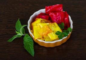 Pickled cabbage in a bowl on wooden background photo