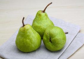 Green pears on wooden background photo