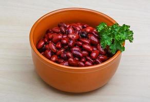 Baked beans in a bowl on wooden background photo